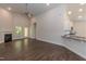 Bright living room with high ceilings, fan, fireplace, and connection to kitchen at 44 Cooper Branch Ct, Fuquay Varina, NC 27526