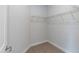 Walk-in closet featuring shelving with a neutral carpet flooring at 44 Cooper Branch Ct, Fuquay Varina, NC 27526