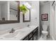Bathroom featuring double vanity sinks, modern fixtures, and a shower at 4617 Fawnbrook Cir, Raleigh, NC 27612