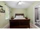 Cozy bedroom with an ensuite bathroom, featuring a dark wood bedframe at 4617 Fawnbrook Cir, Raleigh, NC 27612