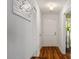 Bright hallway with hardwood floors, fresh paint, coat rack, and neutral colored front door with hardware at 4617 Fawnbrook Cir, Raleigh, NC 27612