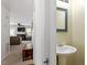 Hallway view with half bathroom, leading to the living room with fireplace at 4617 Fawnbrook Cir, Raleigh, NC 27612