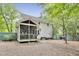 View of the home's back exterior featuring an enclosed porch, siding, and yard at 4711 Buttonbush Dr, Durham, NC 27712
