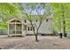 View of the home's back exterior featuring an enclosed porch, siding, and yard at 4711 Buttonbush Dr, Durham, NC 27712