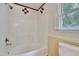 Bathroom with white tub and red accents at 4711 Buttonbush Dr, Durham, NC 27712
