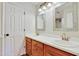 Double vanity bathroom with wood cabinets, sinks, and mirrors at 4711 Buttonbush Dr, Durham, NC 27712