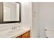 Clean bathroom features a vanity, sink, toilet, and a mirror, perfect for quick morning routines at 4711 Buttonbush Dr, Durham, NC 27712