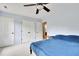 Light-filled bedroom with a ceiling fan, carpet, and ample closet space for convenient storage at 4711 Buttonbush Dr, Durham, NC 27712
