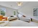 Spacious bedroom featuring two beds, a ceiling fan, and two windows at 4711 Buttonbush Dr, Durham, NC 27712