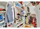 Walk-in closet with built in shelving and clothing at 4711 Buttonbush Dr, Durham, NC 27712