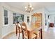 Cozy dining room with a wooden table, a china cabinet, and large bay windows at 4711 Buttonbush Dr, Durham, NC 27712