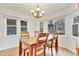 Bright dining room featuring a wooden table with seating for four and natural light at 4711 Buttonbush Dr, Durham, NC 27712