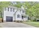 Two-story home with a garage and front porch with swing on landscaped lot at 4711 Buttonbush Dr, Durham, NC 27712