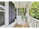 Inviting front porch with a swing, white railing, and views of the surrounding yard at 4711 Buttonbush Dr, Durham, NC 27712