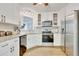 Well-lit kitchen showcases white cabinets, stainless steel appliances, and a functional design for seamless cooking at 4711 Buttonbush Dr, Durham, NC 27712
