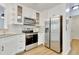 Updated kitchen with white cabinets, stainless steel appliances, and modern fixtures for a stylish and functional space at 4711 Buttonbush Dr, Durham, NC 27712