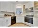 Bright kitchen featuring white cabinetry, granite countertops, and stainless steel appliances for a modern touch at 4711 Buttonbush Dr, Durham, NC 27712