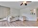 Cozy living room featuring hardwood floors, a large sectional sofa, and a staircase at 4711 Buttonbush Dr, Durham, NC 27712