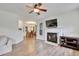 Bright living room with a fireplace, hardwood floors, and an open view into the dining room at 4711 Buttonbush Dr, Durham, NC 27712