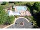 Aerial view of a community pool with lounge chairs and a playground at 4711 Buttonbush Dr, Durham, NC 27712