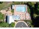 Aerial view of a community pool with lounge chairs and a playground at 4711 Buttonbush Dr, Durham, NC 27712