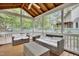Inviting screened porch with wicker furniture and a ceiling fan at 4711 Buttonbush Dr, Durham, NC 27712