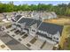 An aerial view showcases a desirable townhome community with mature landscaping and convenient parking at 484 Autumn Rain St, Cary, NC 27519