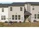 View of the townhouse backyard featuring lush grass, patio and modern exterior at 484 Autumn Rain St, Cary, NC 27519