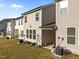 View of townhome backyards with AC units and small gardens, ideal for relaxing and outdoor enjoyment at 484 Autumn Rain St, Cary, NC 27519