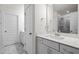 Bright bathroom featuring double doors, a sleek vanity, and marble flooring at 484 Autumn Rain St, Cary, NC 27519