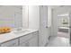 Bathroom featuring white cabinets, quartz countertop, and an open doorway at 484 Autumn Rain St, Cary, NC 27519