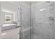 Marble shower with seat, glass door, and view into the adjacent bedroom at 484 Autumn Rain St, Cary, NC 27519