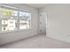 Bright bedroom with large window showcasing a view of the neighboring townhouses at 484 Autumn Rain St, Cary, NC 27519