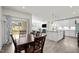 Dining area flows into a modern kitchen and bright living space, with patio access at 484 Autumn Rain St, Cary, NC 27519