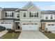 Two-story townhome featuring a two-car garage and neutral gray siding at 484 Autumn Rain St, Cary, NC 27519