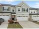 Two-story townhome featuring a two-car garage and neutral gray siding at 484 Autumn Rain St, Cary, NC 27519