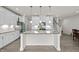 Modern kitchen with large island and staircase at 484 Autumn Rain St, Cary, NC 27519