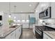 Modern kitchen featuring granite counters and stainless steel appliances at 484 Autumn Rain St, Cary, NC 27519