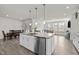 Kitchen featuring a large island with granite counters and stainless steel appliances at 484 Autumn Rain St, Cary, NC 27519