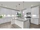 Bright kitchen with granite counters, white cabinets, and stainless steel appliances at 484 Autumn Rain St, Cary, NC 27519