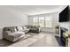Bright living room boasts a fireplace, ample windows, and a comfortable sectional sofa at 484 Autumn Rain St, Cary, NC 27519
