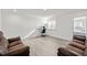 Well-lit room featuring vinyl floor, dual sofas, and window with blind shades at 484 Autumn Rain St, Cary, NC 27519