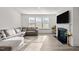 Bright living room boasts a fireplace, ample windows, and a comfortable sectional sofa at 484 Autumn Rain St, Cary, NC 27519