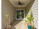 A private patio with plants is ideal for outdoor living and relaxation with a ceiling fan at 484 Autumn Rain St, Cary, NC 27519