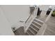 Staircase features wood handrail and white risers, leading to the upper level living spaces at 484 Autumn Rain St, Cary, NC 27519