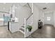 Elegant staircase with white railings connects the home's floors near the modern kitchen at 484 Autumn Rain St, Cary, NC 27519