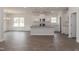 Open-concept kitchen featuring a center island, granite countertops, and modern white cabinets at 50 Watermelon Dr, Franklinton, NC 27525