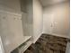 Mud room featuring built-in bench, coat hooks, and tile floors at 50 Watermelon Dr, Franklinton, NC 27525
