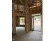 Unfinished room with framed walls, exposed ceiling, and a door leading outside with natural light at 50 Watermelon Dr, Franklinton, NC 27525