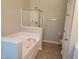 Bright bathroom with a large soaking tub, a glass enclosed shower, and tile floors at 5033 Amber Clay Ln, Raleigh, NC 27612